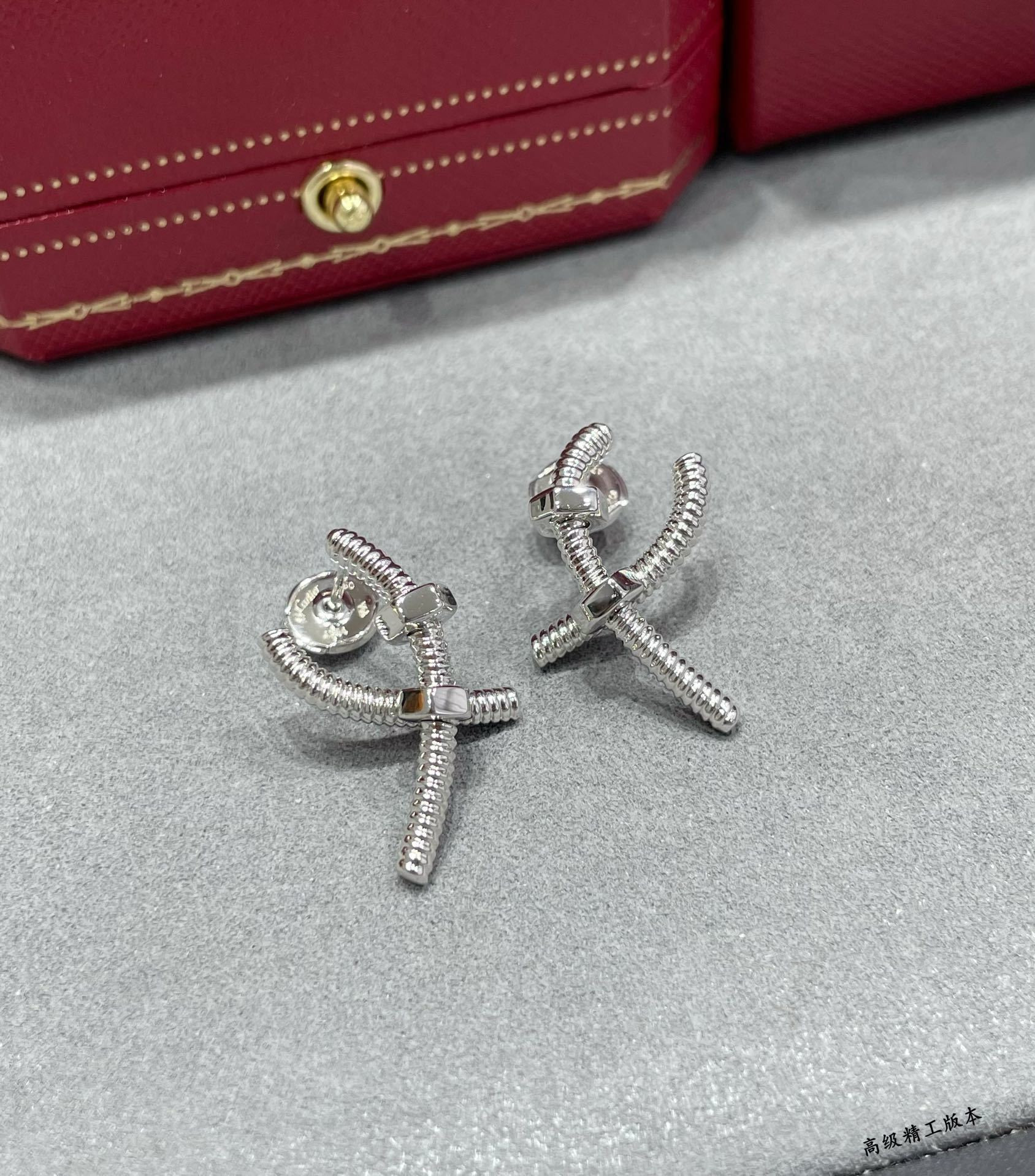 Ca*t*er cross screw earrings
