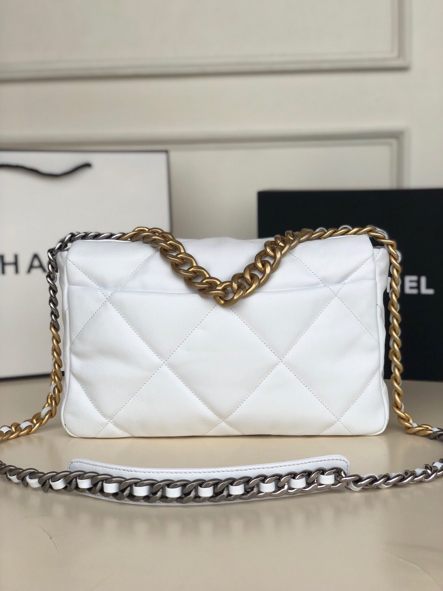 Ch*el 19 large handbag shiny leather, gold-tone, silver-tone & ruthenium-finish metal white 7.8 × 11.7 × 3.9 in