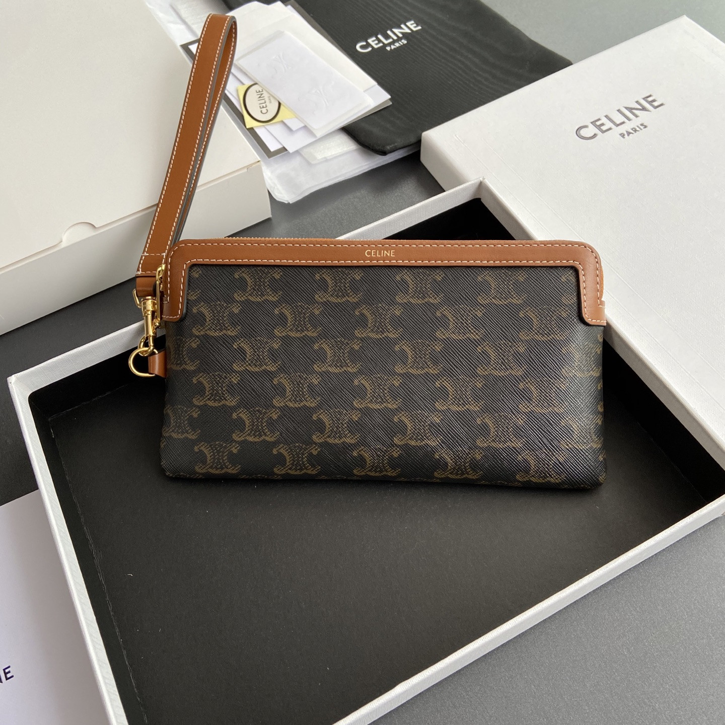 Ce**e long pouch with strap in triomphe canvas and calfskin 21.5x11.5x1cm